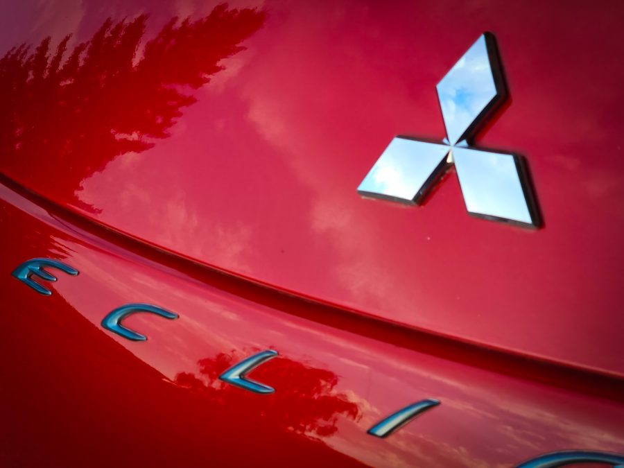 Closup of Mitsubishi logo on red Eclipse sports car